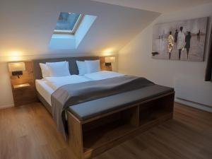 a bedroom with a large bed with a skylight at Gästehaus Rossfall 424 - Self-Check-in in Urnäsch