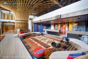 a lobby with couches and tables in a building at Mandala Wins Hotel Phú Yên in Phước Hậu