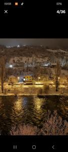 a picture of a city with a river and buildings at Lux apartman in Banja Luka