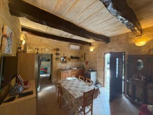a kitchen with a table and a refrigerator at Razzett ta' Sinna in Għargħur