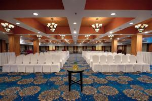 a row of white chairs in a banquet hall at Radisson Blu Kochi in Cochin +55 photos