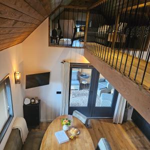 a living room with a table and a staircase at MOI -Magnifiek Overnachten In- Meppen in Meppen +24 photos