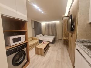 a small room with a kitchen and a microwave at Cozy Homes in Cairo
