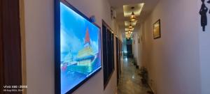 a large flat screen tv hanging on a wall at Hotel Prince palace in Ayodhya