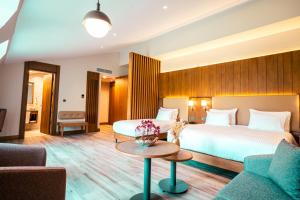 a hotel room with a bed and a table at Wellwood Otel in Sapanca