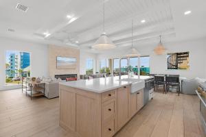 an open kitchen and living room with a couch at Sea View Play in New Smyrna Beach