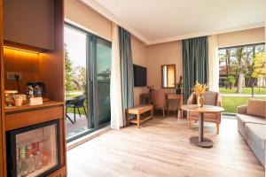 a living room with a fireplace and a couch at Wellwood Otel in Sapanca