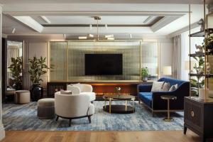 a living room with a couch and a tv at The Ritz-Carlton, Berlin in Berlin