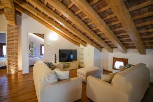 a living room with two couches and a tv at Alla Rocca Storica in Cavallino-Treporti