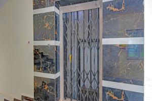 a door in a room with a wall at FabHotel Srikara Grand Luxury Rooms in Hyderabad