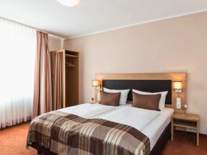 Postel nebo postele na pokoji v ubytování Hotel Sarah