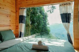 a bedroom with a bed and a large window at D Home Sapa 10 in Sapa