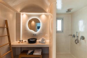 a bathroom with a sink and a shower at Oikos Santorini Living Concept in Fira +40 photos