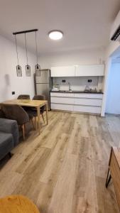 a living room with a table and a kitchen at Kings Apartments in Tiberias