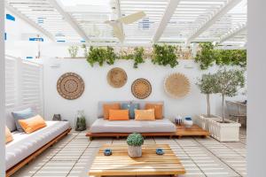 a living room with a couch and a table at Sifnos House - Rooms and SPA in Kamarai