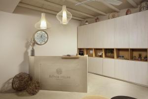 a large room with a clock on the wall at Sifnos House - Rooms and SPA in Kamarai +107 photos