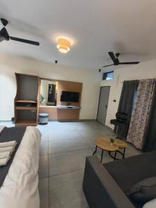 a living room with a couch and a table at Peach stay in Mount Ābu