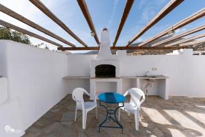 a kitchen with a table and chairs and a stove at Horizon House in Paros, Cyclades in Drios