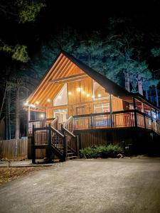 a wooden cabin with a porch and a fence at Moki Pines Chalet - Stylish Stay Among the Pines in Flagstaff