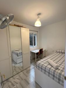 a bedroom with a bed and a mirror and a desk at Casa Micho in Tomares +40 photos