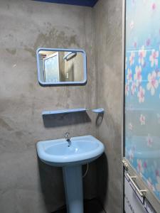 a bathroom with a sink and a mirror at Manha Blue Villa Arugambay in Arugam Bay