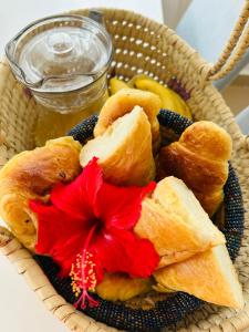 a basket of food with a red flower on it at U Paradisu Villas-Jambiani in Kibigija