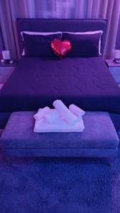 a bed with a red heart on top of it at Luxury Suite Quartu in Quartu SantʼElena +8 photos