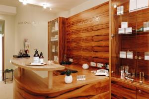 a dressing room with a wooden wall and a table at Appartements Gut Berg in Sankt Johann im Pongau