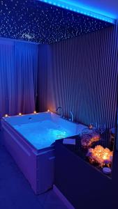 a large bath tub in a room with stars on the ceiling at Luxury Suite Quartu in Quartu SantʼElena