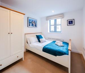 a bedroom with a large bed with blue sheets at Central 2BR flat - free parking - fast Wi-Fi in Bristol