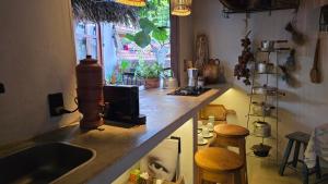 a kitchen with a counter with a sink and a window at Quintal da Cuiarana - 50M da praia principal de Alter do Chão in Alter do Chao +52 photos