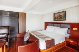 a bedroom with a bed and a desk and a chair at Swiss Lenana Mount Hotel in Nairobi +48 photos