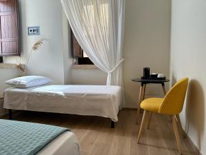 a room with two beds and a table and a chair at al Vico Bedrooms in Crotone +20 photos