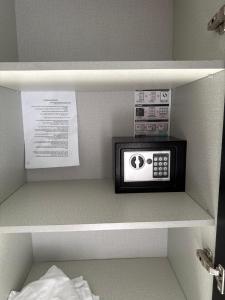 een kleine magnetron op een plank in een kamer bij סי סייד אילת חדר משפחתי עם מרפסת ונוף לים ולבריכה in Eilat