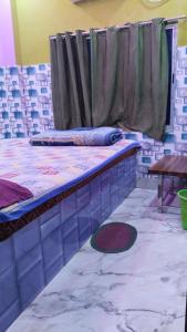 Postel nebo postele na pokoji v ubytování New SRI GURU BHAVAN