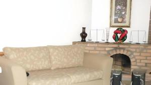 a living room with a couch and a fireplace at The Niwasa Resident in Nuwara Eliya