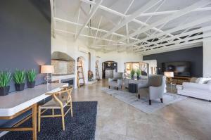 ein Wohnzimmer mit einer Couch und einem Tisch und Stühlen in der Unterkunft Luxury Coastal Living with Sea and Mountain View in Big Bay