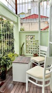 a patio with two chairs and a table on a balcony at Hanoi Brilliant Home in Hanoi