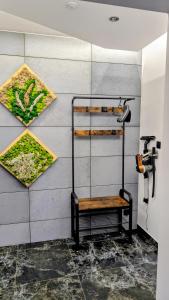a shower stall with a bench on a wall at Zajazd u George'a in Ziębice