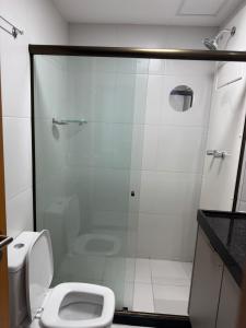 a bathroom with a shower and a toilet at Makia Beach experience 107 D Premium in Ipojuca +3 photos