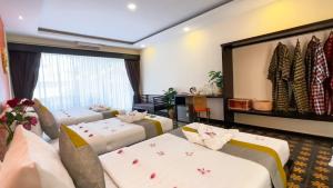 Postel nebo postele na pokoji v ubytování Indochine Sanctuary Boutique Hotel