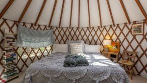 a bedroom with a bed in a yurt at Cozy Romantic Yurt Rental in Woodlands near California Beach Town of Cayucos in Cayucos