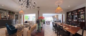 a dining room with a long table and chairs at 58 On Hume in Johannesburg