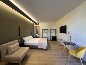 a hotel room with a bed and a table and chairs at al Vico Bedrooms in Crotone
