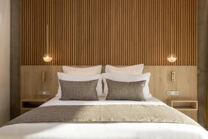 a bedroom with a large bed with two pillows at Hôtel Spa Restaurant Villa Castellane by Germain Collection in Gréoux-les-Bains