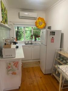 a kitchen with a white refrigerator and a window at Birchmoore Studio in Penola +20 photos