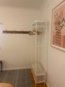 a glass shelf in a room with a painting at Birchmoore Studio in Penola