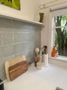 a kitchen counter with a cutting board and a window at Birchmoore Studio in Penola