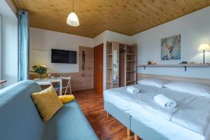 a bedroom with a large bed and a couch at Szymonówka W Szklarskiej Porębie in Szklarska Poręba