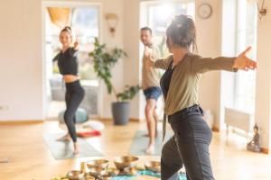 a group of people doing yoga in a living room at Hotel Pirchnerhof in Reith im Alpbachtal